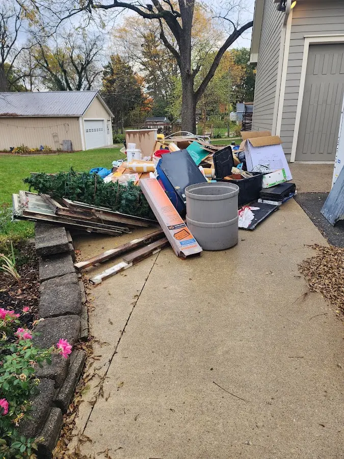 Dumpster being loaded with debris for Estate Cleanout Dumpster Rental in Tellico Village